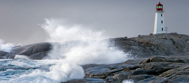 Image of a lighthouse next to the ocean.